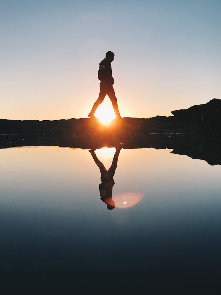 Silhouette Of Man Walking Near The Ocean