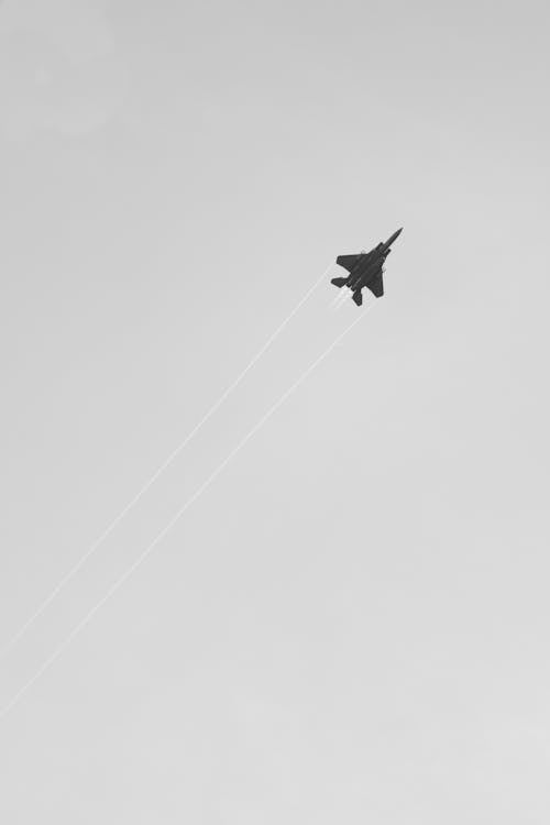 Fighter plane flying in gray sky