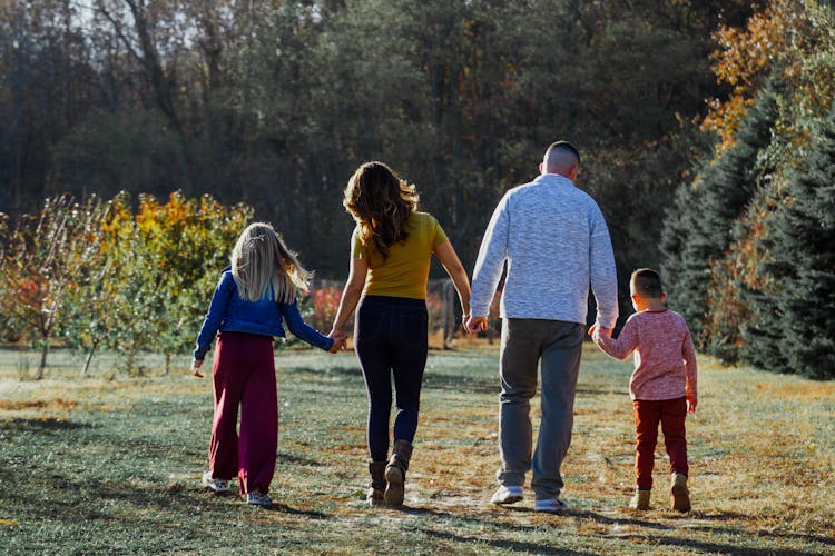 Happy Family Walking In Countryside