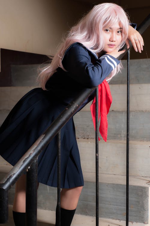 Free Girl in Pink Wig and School Uniform on Staircase Stock Photo