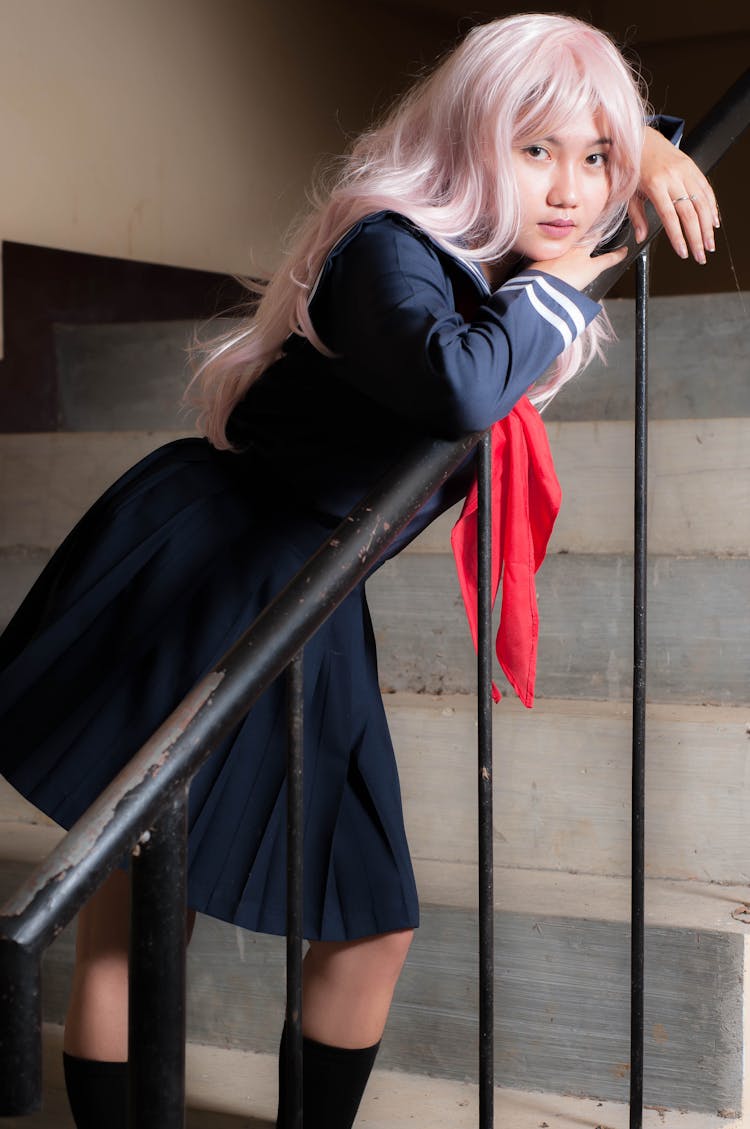 Girl In Pink Wig And School Uniform On Staircase