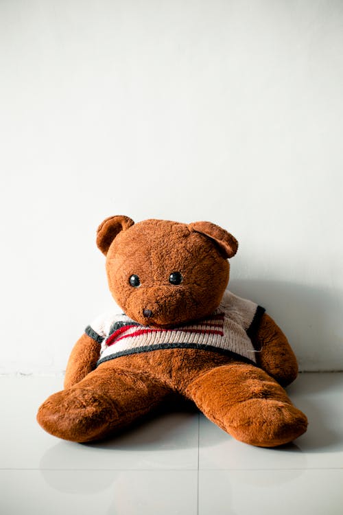 Free Brown Bear Plush Toy on White Surface Stock Photo