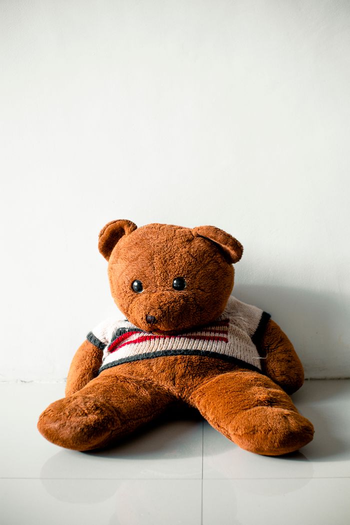 An orange plush bear on a pale backdrop — photo by Nothing Ahead on Pexels