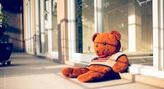 Soft bear in knitwear with American flag ornament in sunshine