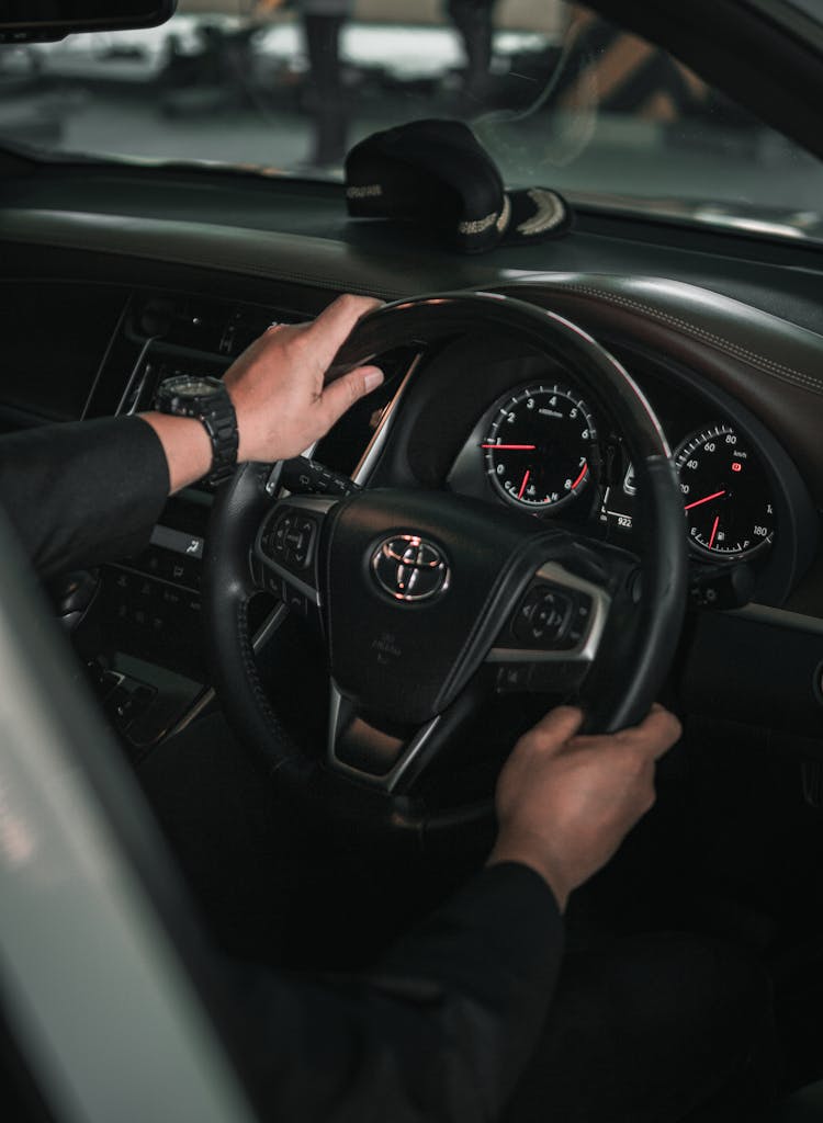 Person Wearing Black Wristwatch Driving A Car