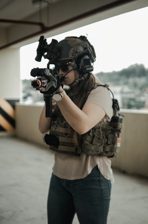 Person in Safety Gear Holding an Armalite