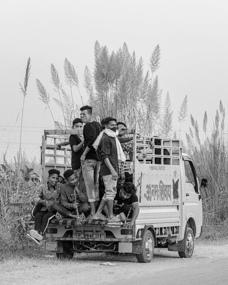 People Riding A Truck