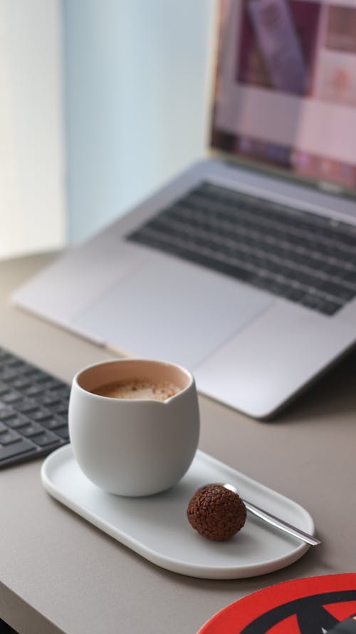 A Cup of Hot Chocolate Near a Laptop