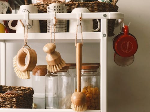 Brown Wooden Brush Hanging on White Plastic Rack