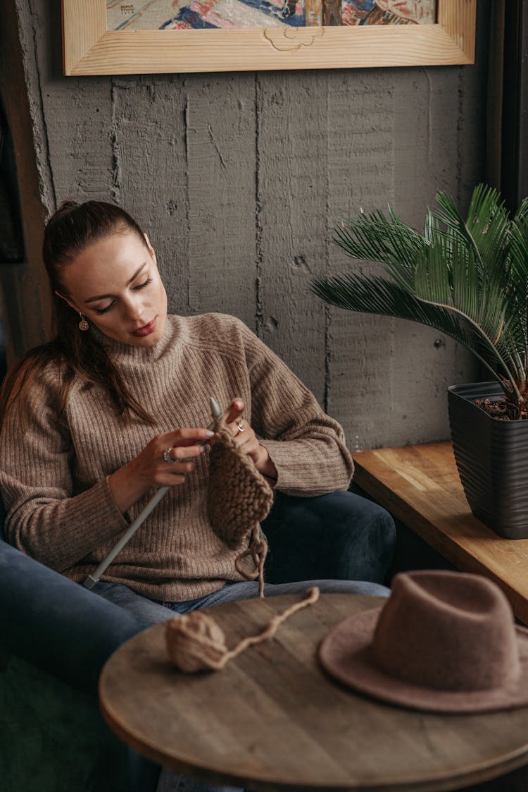 Woman In Brown Sweater Knitting 