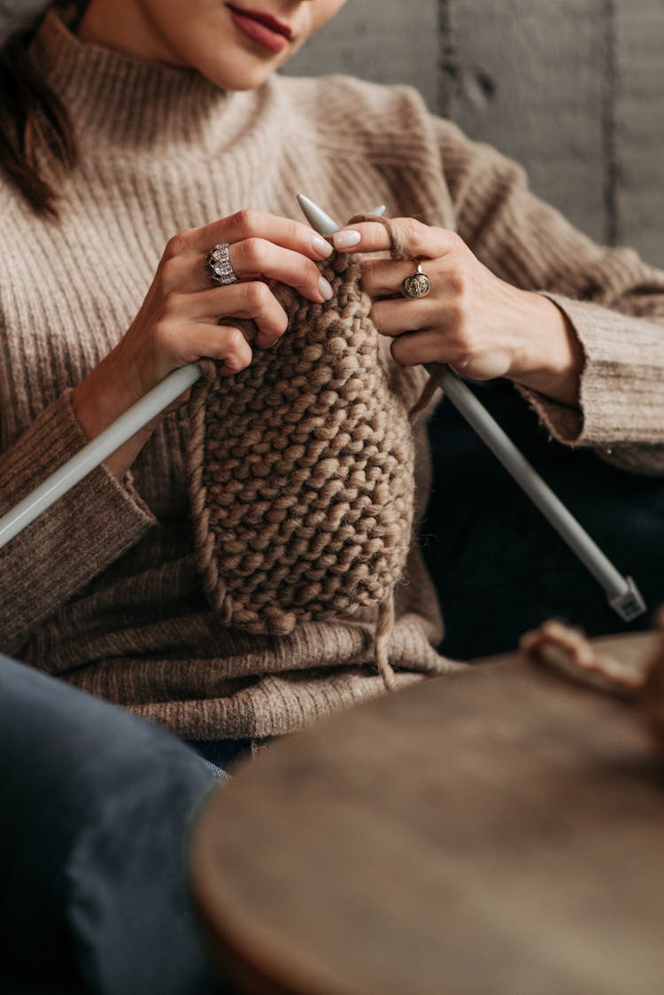 Woman Knitting A Brown Yarn