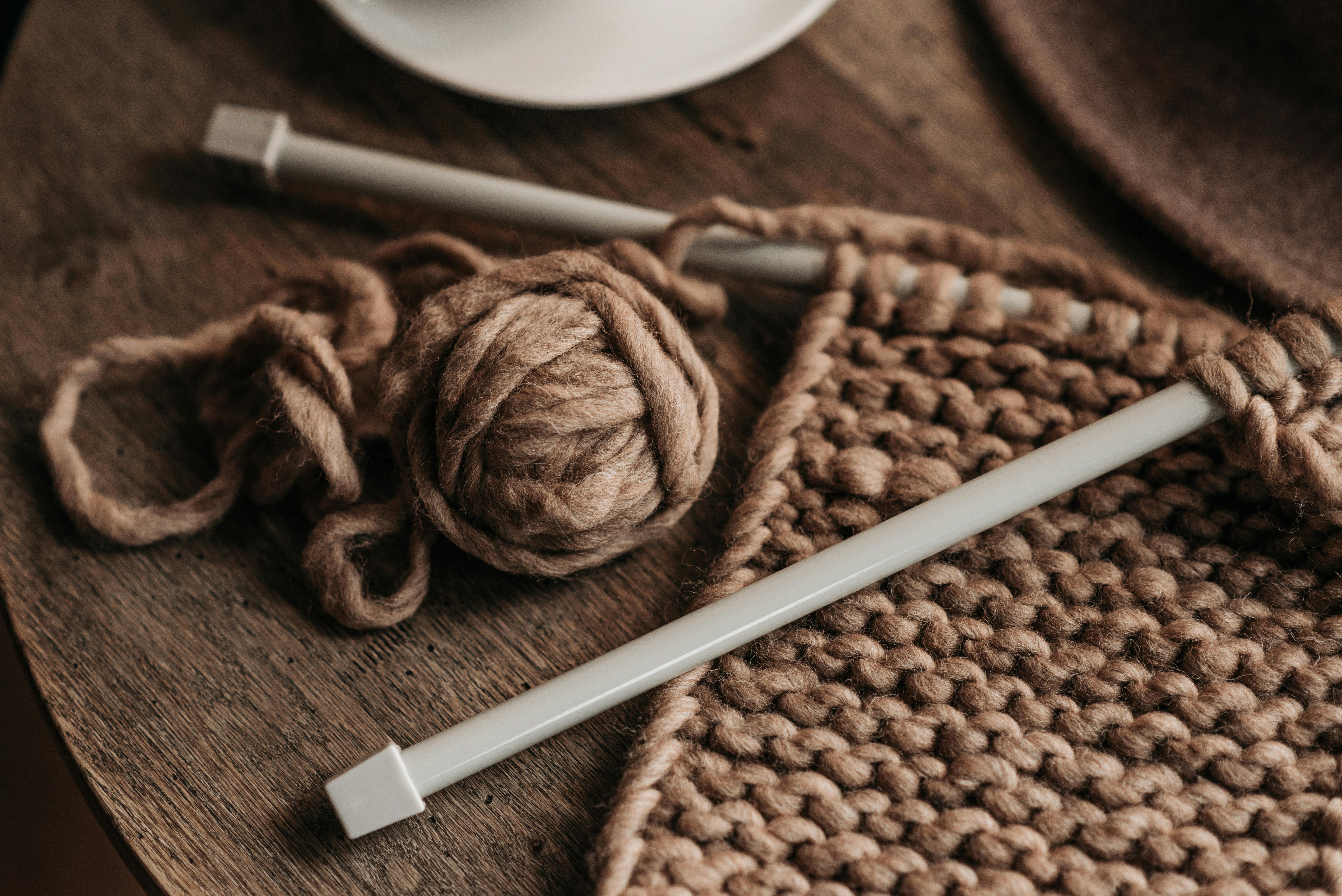 Natural Yarn And Wooden Knitting Needles On Chair by Stocksy