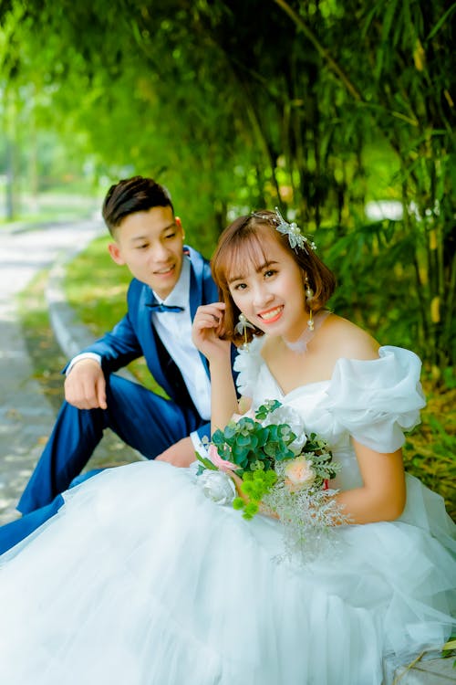 Woman in White Wedding Gown Beside Man in Blue Suit · Free Stock Photo Woman In White Wedding Gown Beside Man In Blue Suit · Free Stock Photo