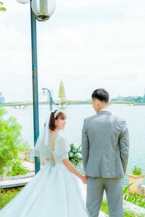 Man in Gray Suit Jacket Beside a Woman in Wedding Dress