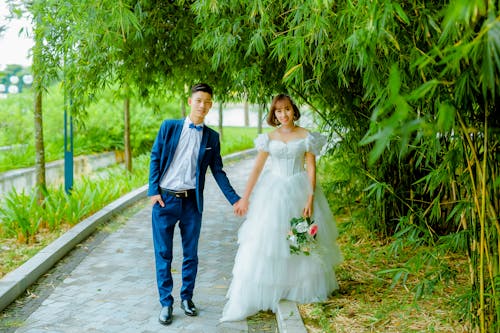Man in Blue Suit Jacket and Woman in White Wedding Dress