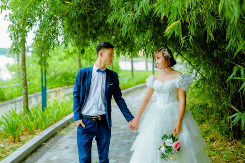 Man in Blue Suit Jacket and Woman in White Wedding Dress