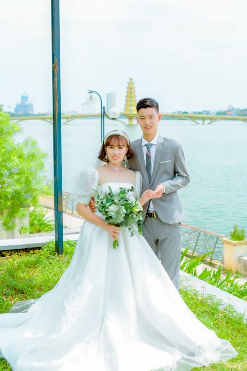 Man in Gray Suit Jacket and Woman in White Wedding Dress