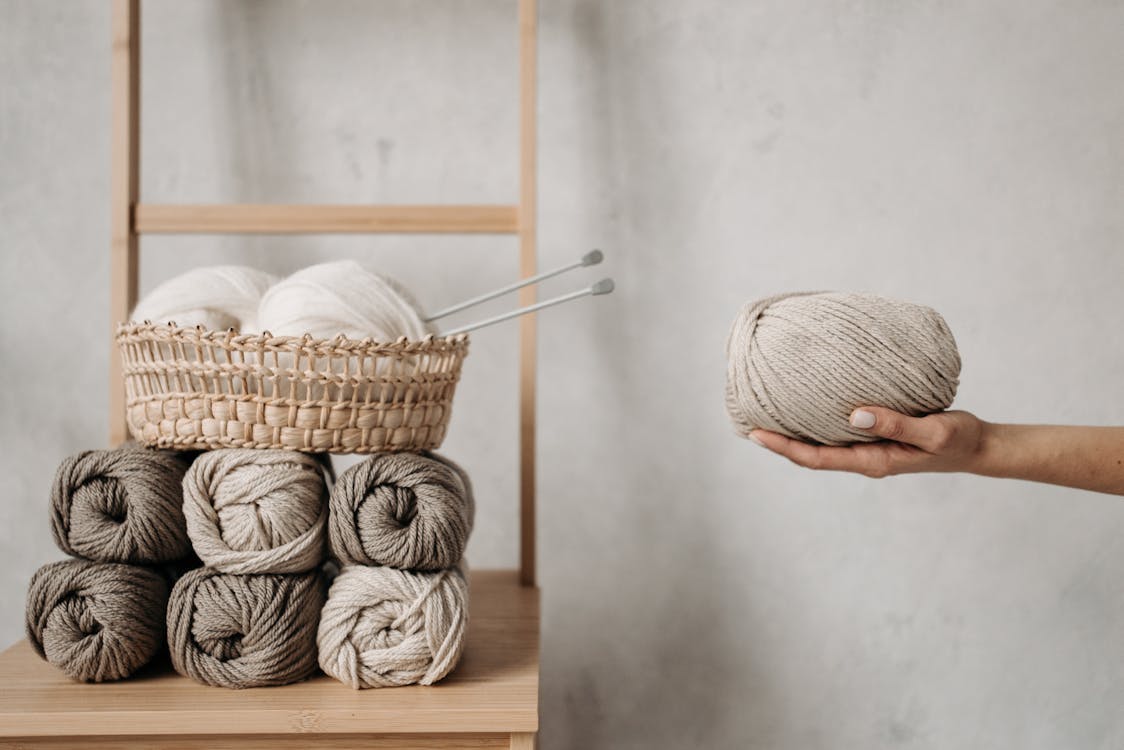 Free A Roll of Yarn on a Person's Hand Stock Photo