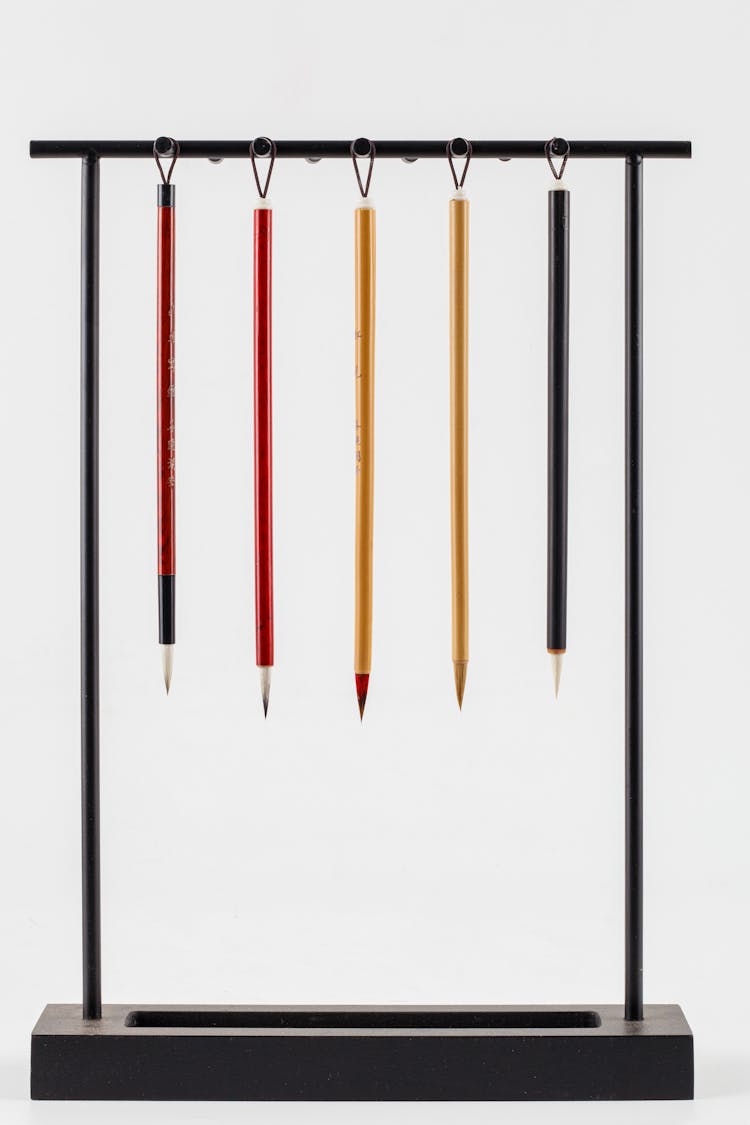 Set Of Calligraphy Brush Pens Hanging On Holder