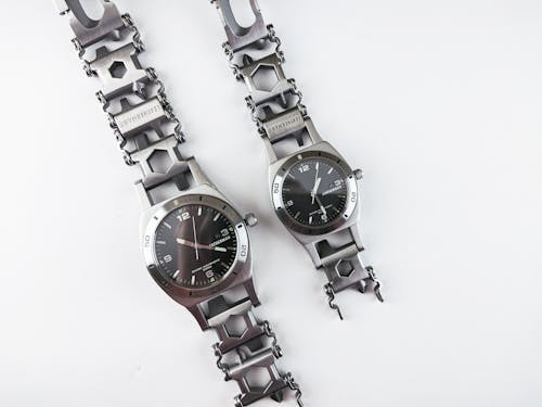 Free Close-Up Shot of Silver Wristwatches on a White Surface Stock Photo