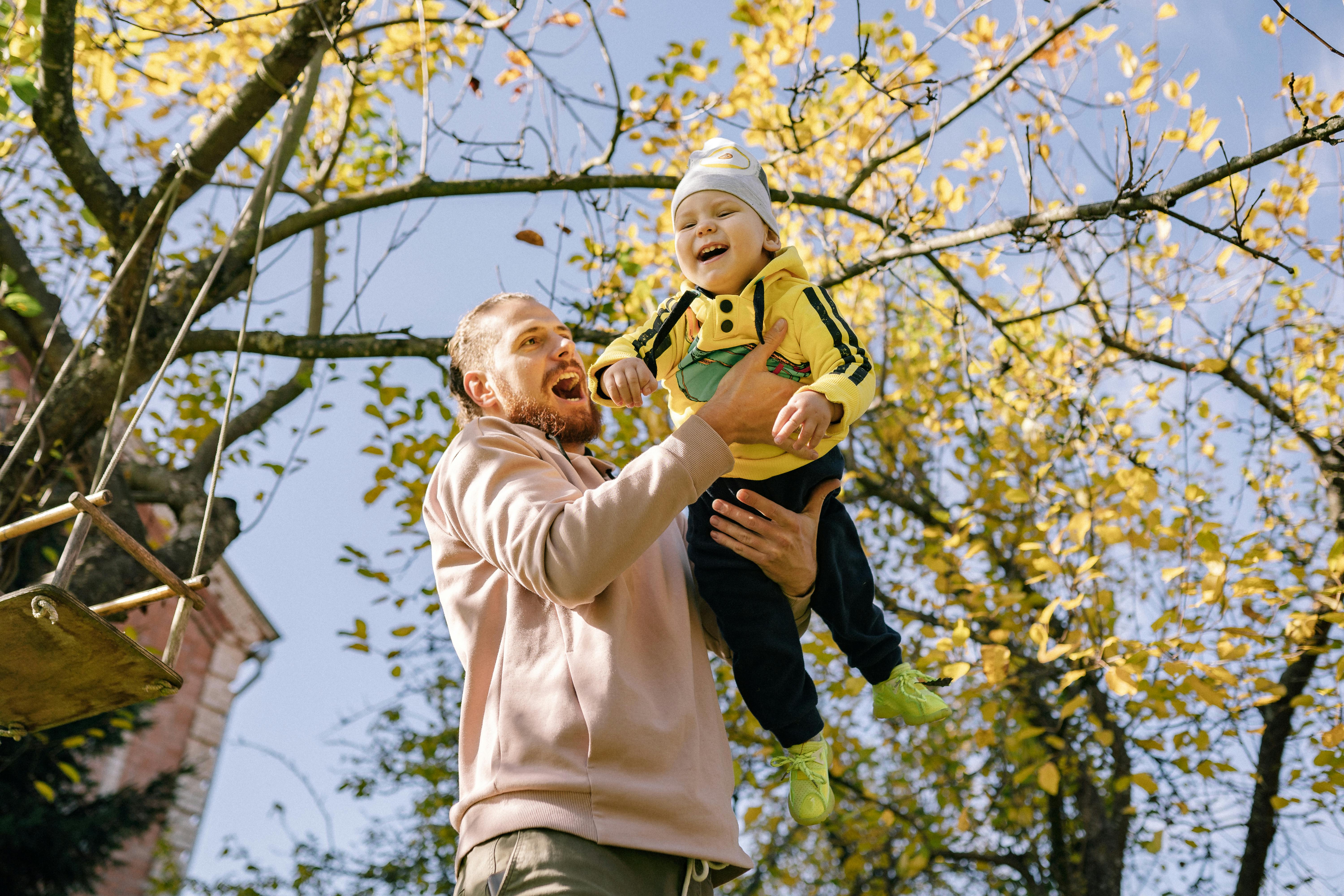 Man Carrying Baby Outside
