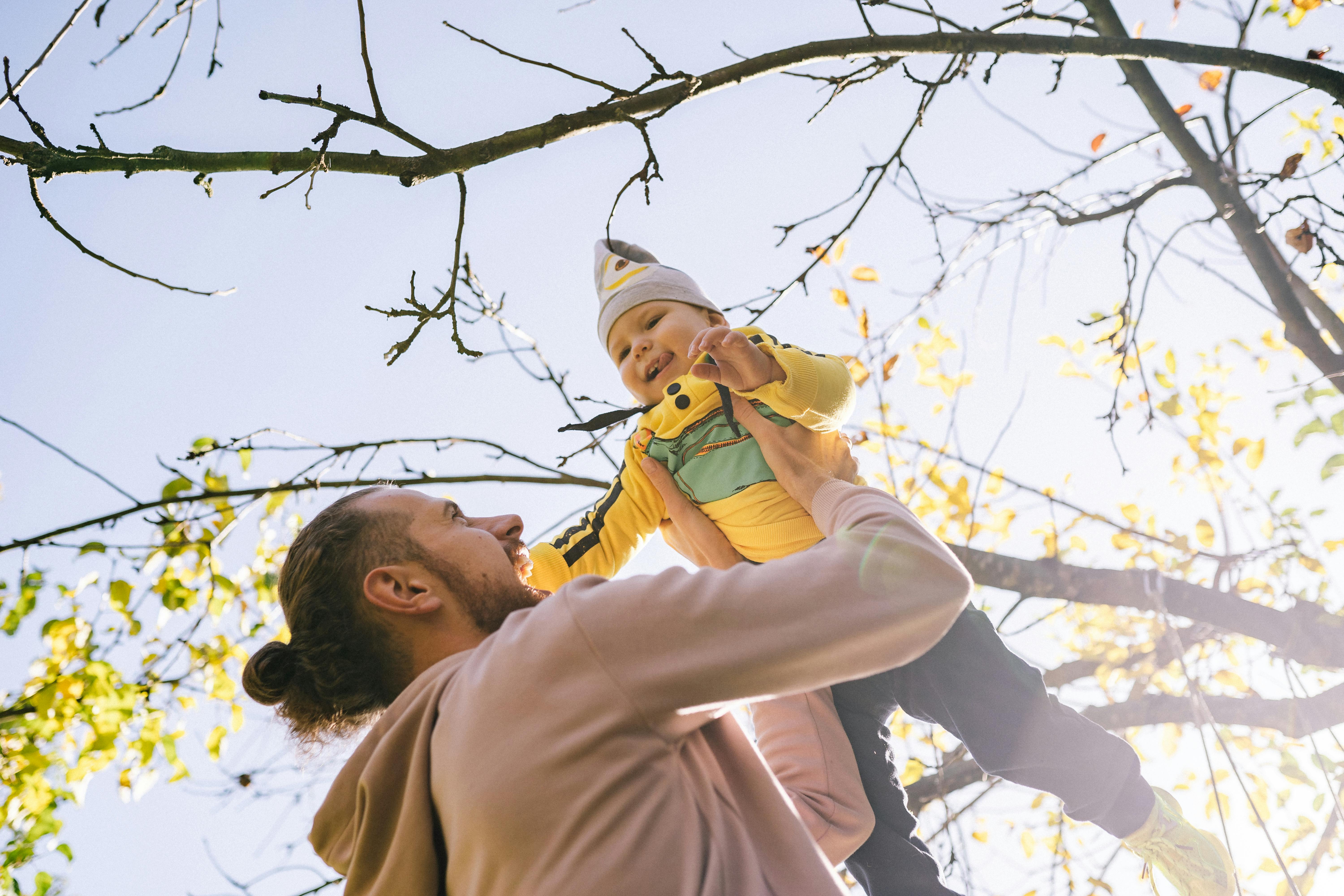 family laughing and playing together outdoors - mindful parenting techniques