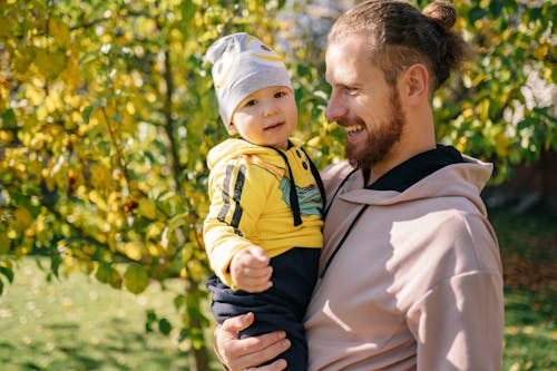 Man Carrying Baby Outside