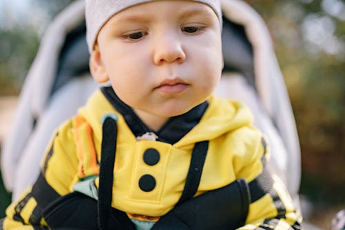 Close-Up Shot of a Cute Baby in Yellow Jacket