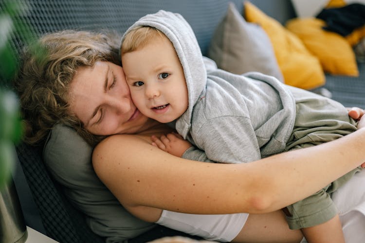 Portrait Of A Woman And Child Cuddling And Lying Down