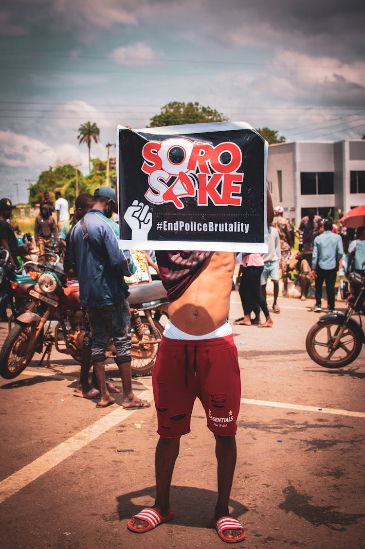 Protester Against Police Brutality Holding Poster In Hands