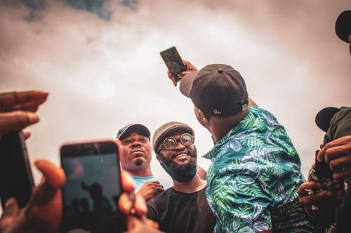 Free A cheerful group of adults capturing a selfie together outdoors, showcasing friendship and technology. Stock Photo
