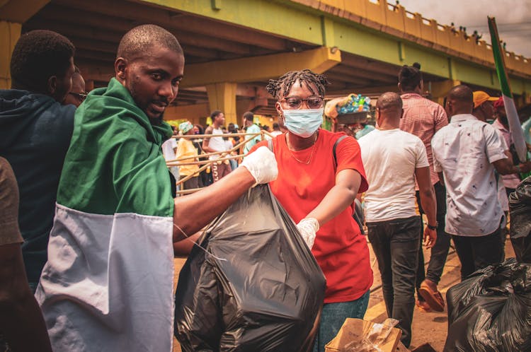 A Group Of People Collecting Garbage