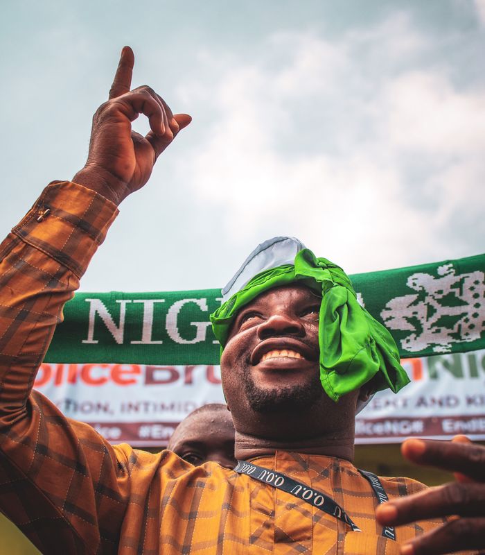 A football fan celebrating a goal in the stands