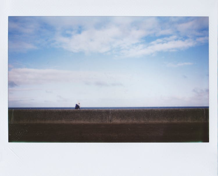 Polaroid Photo Of A Wall Near The Beach