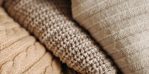 A detailed close-up of assorted knitted textiles showcasing different patterns and textures.