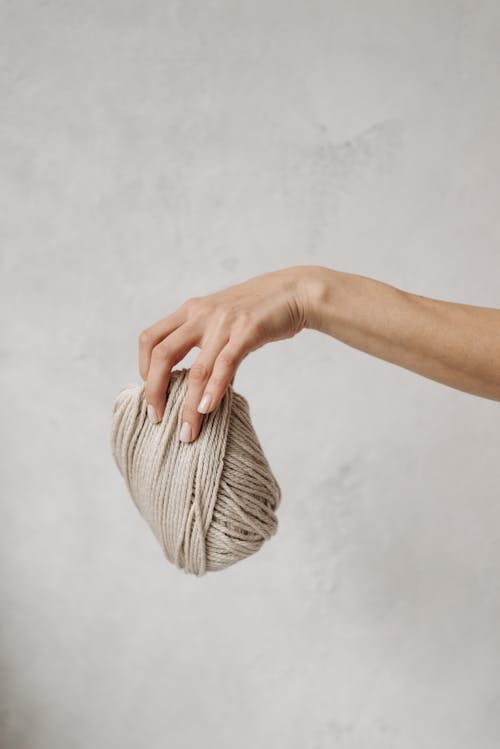 Person Holding Brown Yarn