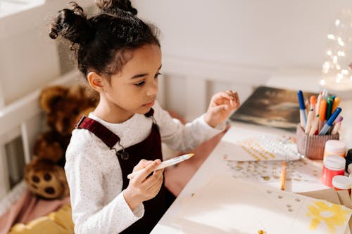 Girl in White Sweater Doing an Artwork