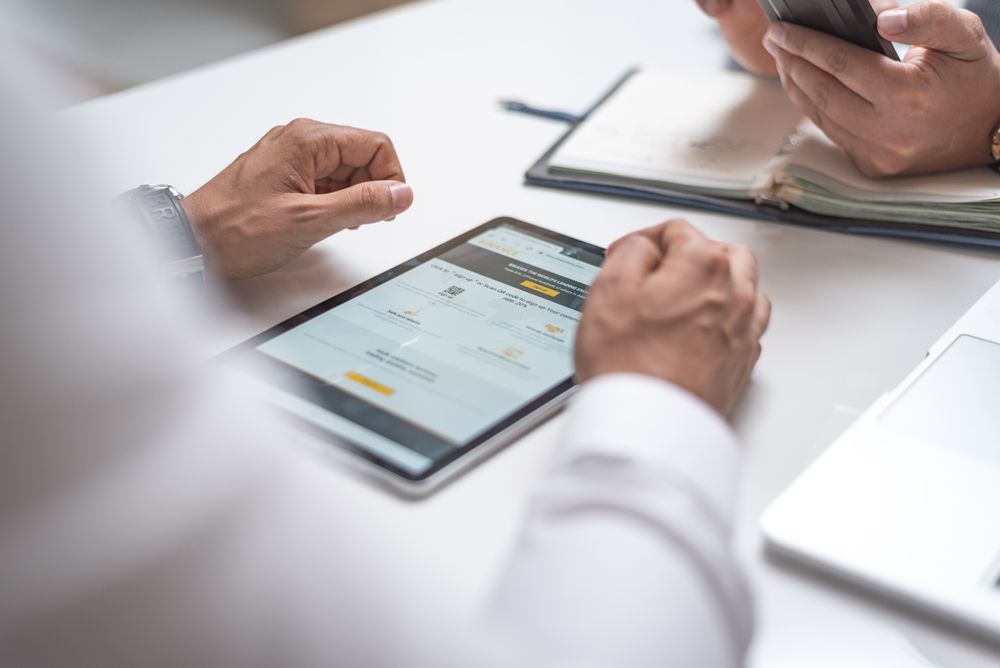 Person using tablet with fraud protection interface
