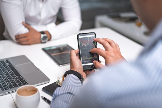 Business professionals using smartphone for data analysis in a modern office setting.