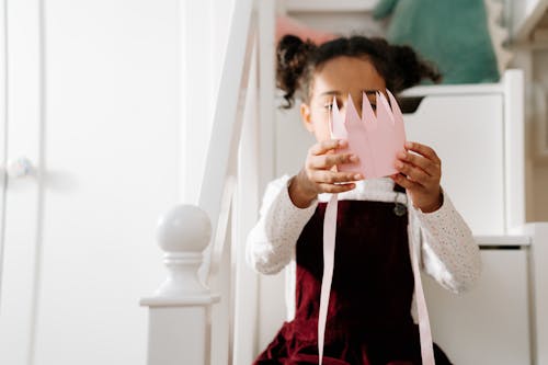 Girl Holding a Paper Crown