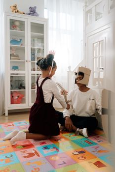 Children engaging in imaginative play with costumes indoors.
