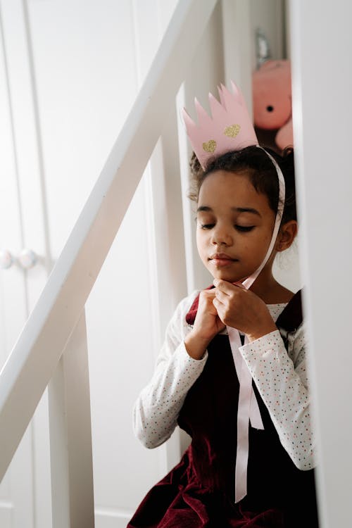 Girl Putting on a Paper Crown