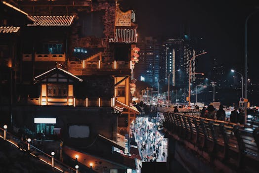 Vibrant night scene of a bustling city street, contrasting traditional and modern architecture.