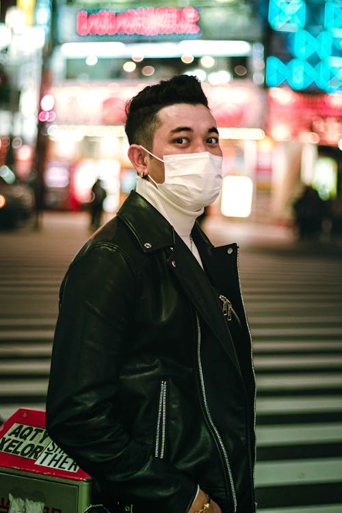 Man in Black Leather Jacket Wearing White Mask
