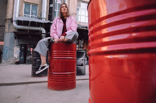 Serious young woman with grimace in urban area