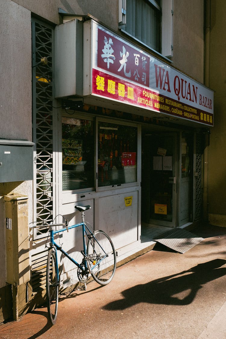 Blue Bike Parked In Front Of A Store