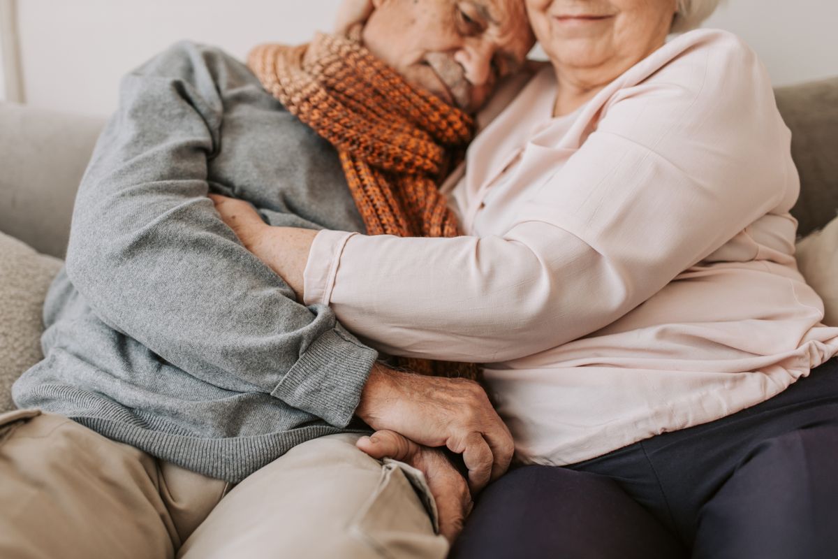 An elderly couple sharing a heartfelt embrace, symbolizing love and companionship.