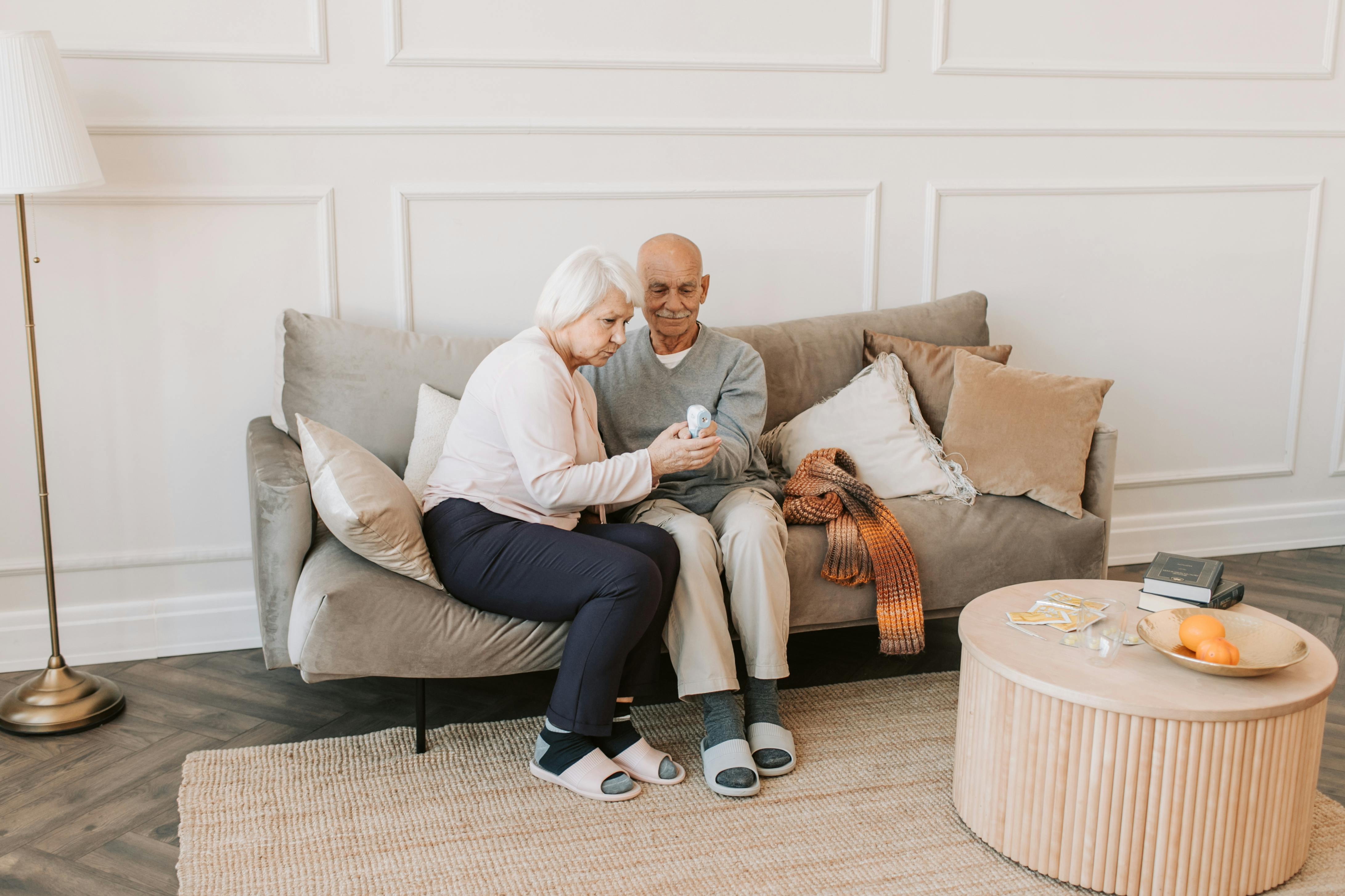 man and woman sitting on white couch