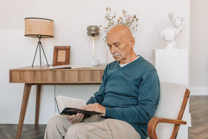 Senior relaxing at home with a book