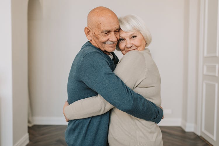 Portrait Of A Happy Elderly Couple Hugging Each Other